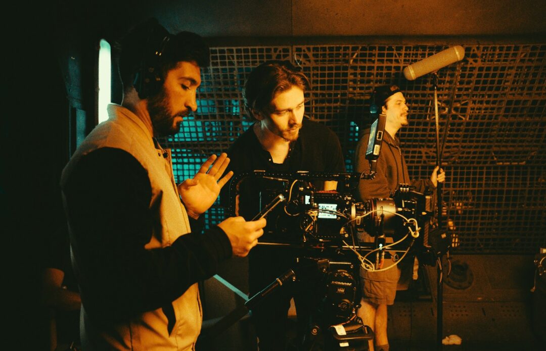 A film crew around a camera on set